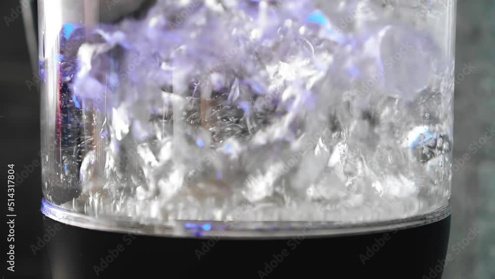 Close-up of the boiling water in the boiling kettle in the kitchen. Cool close-up shots Close-up of the boiling water in the boiling kettle in the kitchen. Cool close-up shots
