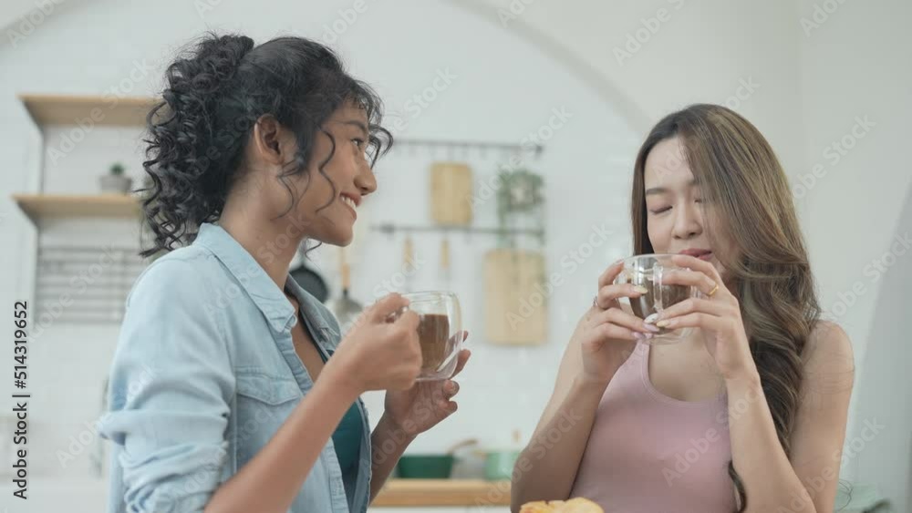 Holiday concept of 4k Resolution. Asian women having coffee together in the kitchen. Young women are in a mutual lesbian love relationship. Holiday concept of 4k Resolution. Asian women having coffee together in the kitchen. Young women are in a mutual lesbian love relationship.