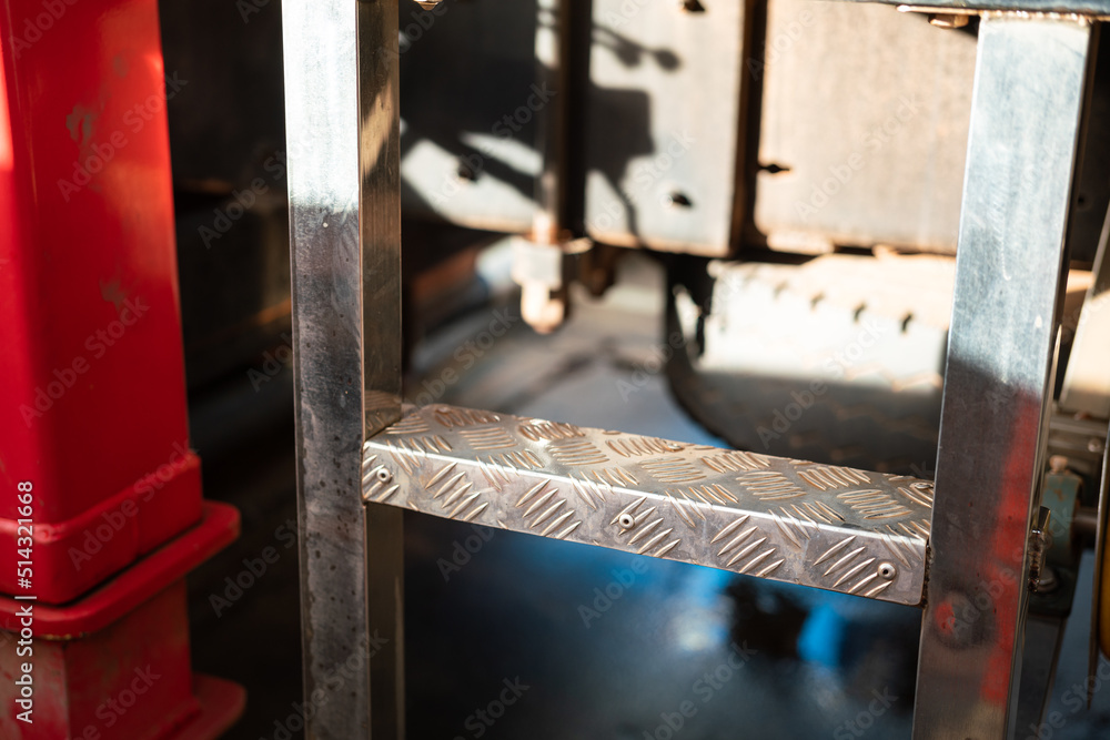 Close-up at the climbing step ladder of a trailer truck or crane machine. Industrial and transportation part object photo. Close-up at the climbing step ladder of a trailer truck or crane machine. Industrial and transportation part object photo.