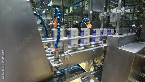 Workers work hard on the dairy production line in Mengniu Dairy Co., Ltd, North China