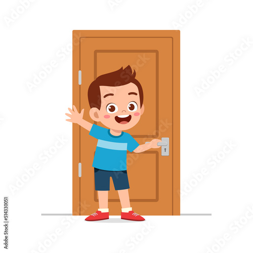 little kid standing and holding door knob