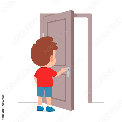 little kid standing and holding door knob