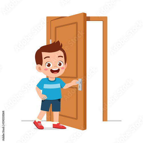 little kid standing and holding door knob