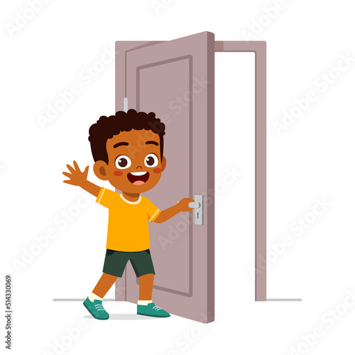 little kid standing and holding door knob