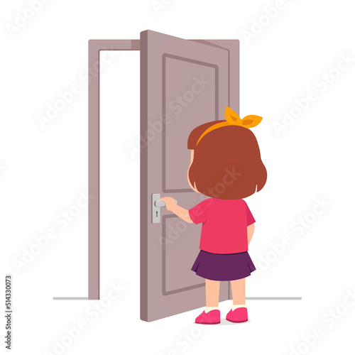 little kid standing and holding door knob