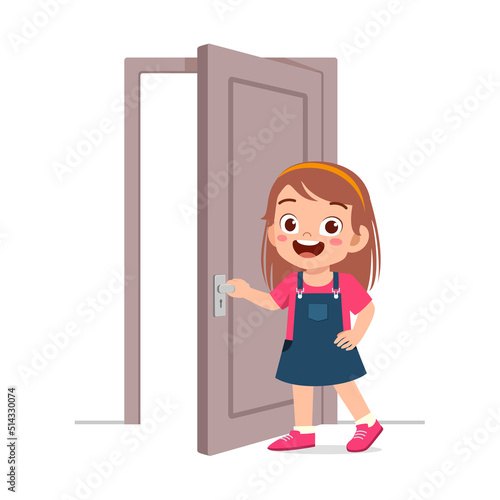 little kid standing and holding door knob
