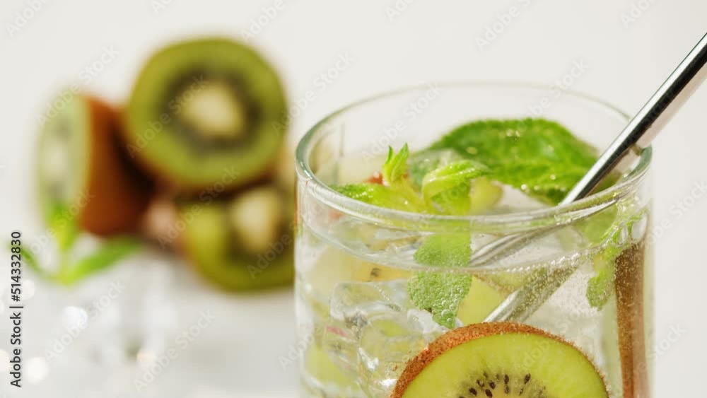 Kiwi lemonade. Fruit cocktail close-up, healthy drink on white background. Detox drinking, summer refreshment concept. Kiwi lemonade. Fruit cocktail close-up, healthy drink on white background. Detox drinking, summer refreshment concept.