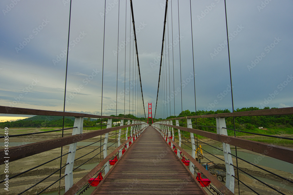 Red suspension bridge of Agongdian Reservoir. The first reservoir to be completed in Taiwan after World War II. Kaohsiung City, 2022