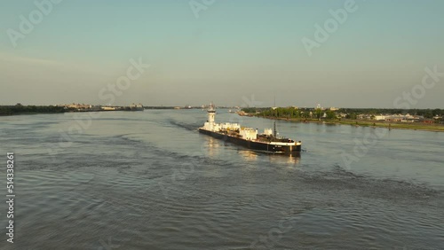 Barge and Pushboat heading down the Mississippi River near New Orleans photo