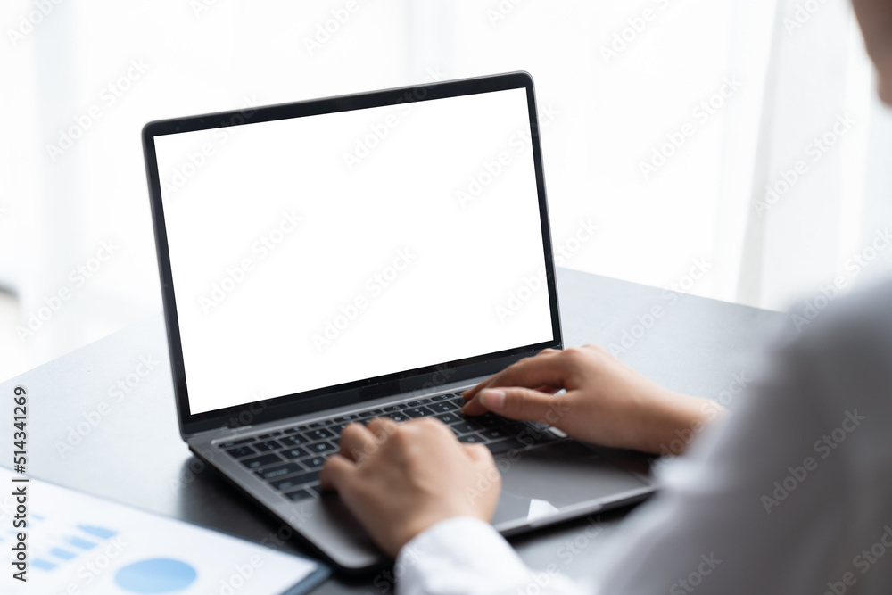Mockup image of business woman using and typing on laptop with blank white screen. Mockup image of business woman using and typing on laptop with blank white screen.