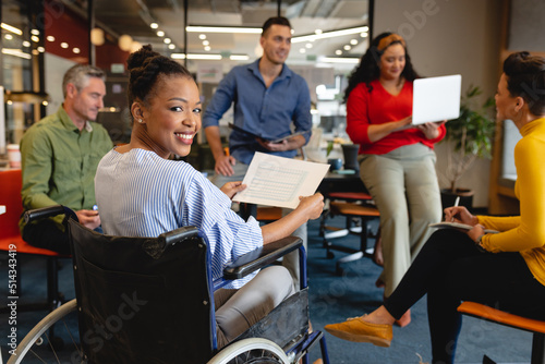 Portrait of smiling african american businesswoman with disability in meeting at office photo