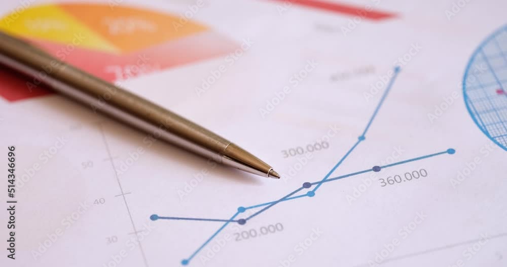 Paper document with charts and pen on table closeup Paper document with charts and pen on table closeup