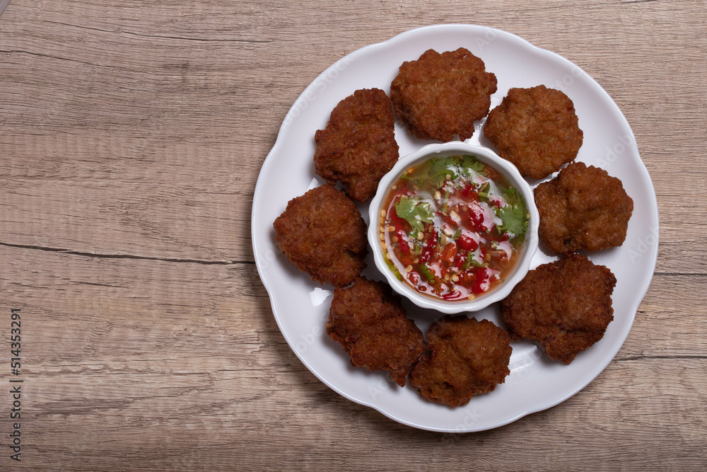 Fried Pork Cake with Ketchup and Chili Sauce on a white table top view. Asia Travel Cuisine concept. Fried Pork Cake with Ketchup and Chili Sauce on a white table top view. Asia Travel Cuisine concept.