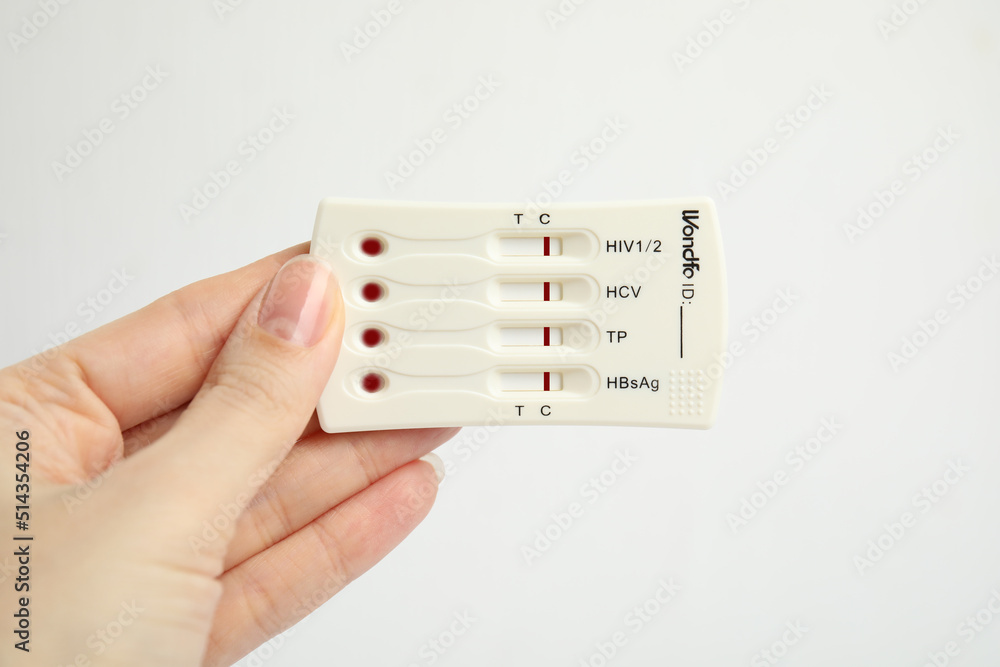 Woman holding disposable express test for hepatitis on white background, closeup Woman holding disposable express test for hepatitis on white background, closeup