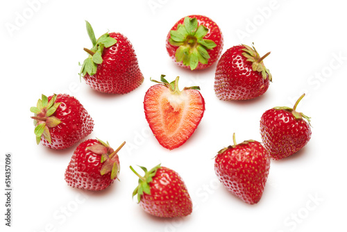 strawberries isolated on white background, red berries whole and sliced in details, concept of fresh fruits and healthy food