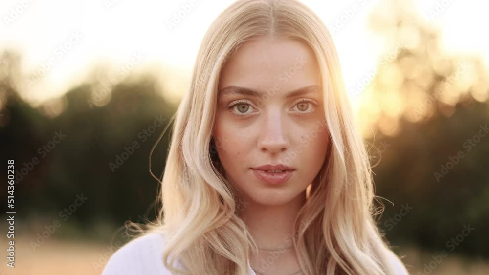 Portrait of beautiful blond woman with long hair. Sunny face of gorgeous girl looking to camera. Portrait of beautiful blond woman with long hair. Sunny face of gorgeous girl looking to camera.