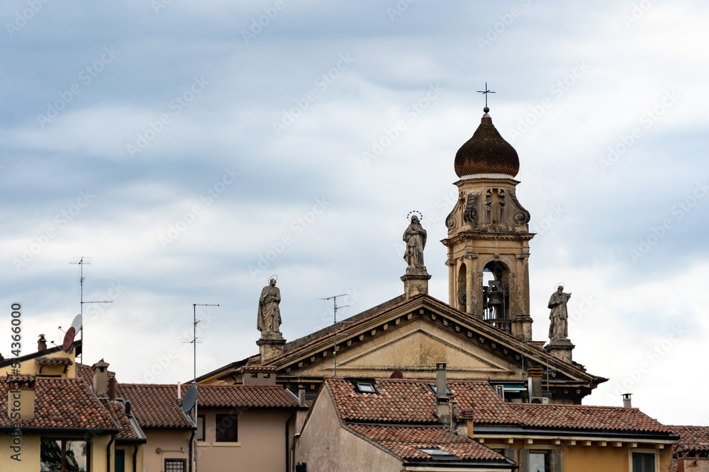 View of Verona roofs with a church and statues