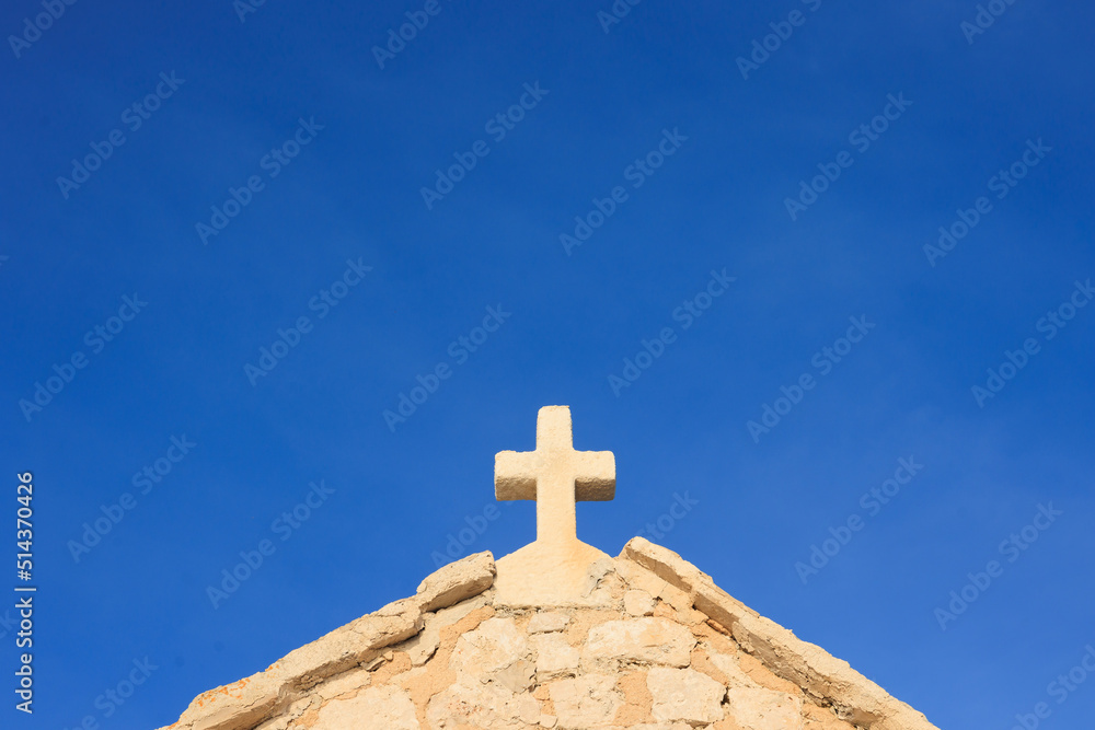 Christian cross symbol on blue sky background