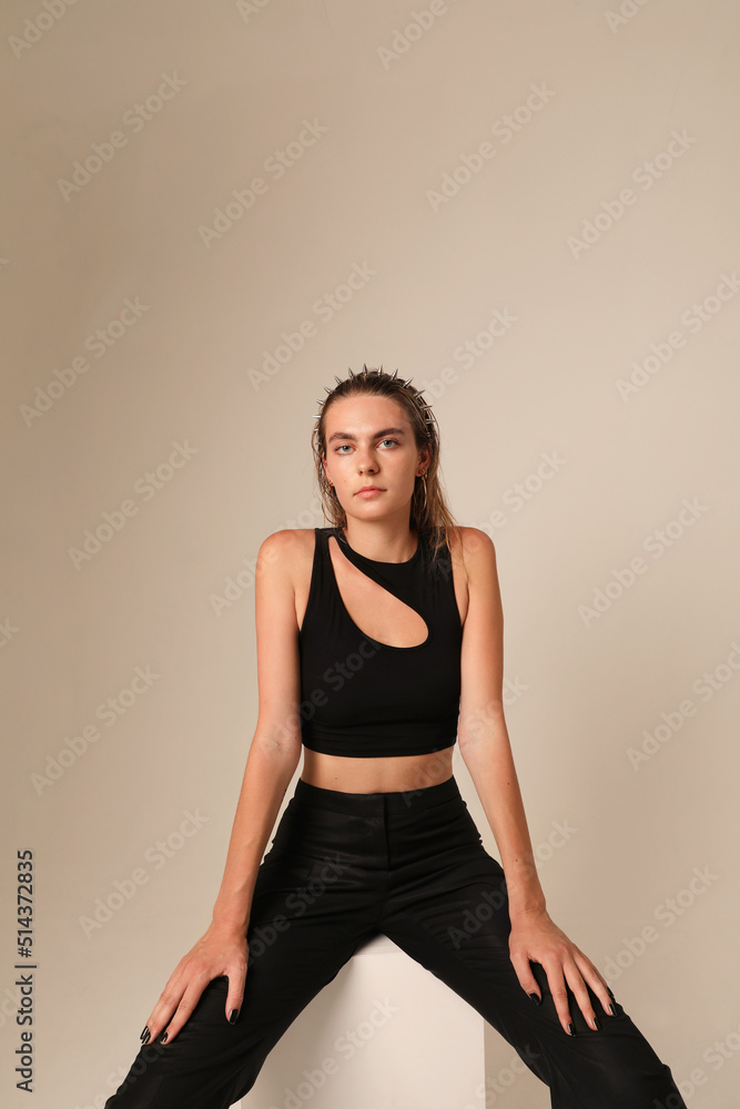 Vertical portrait of young woman poses indoor, poses on white. Mind set concept. Vertical portrait of young woman poses indoor, poses on white. Mind set concept.