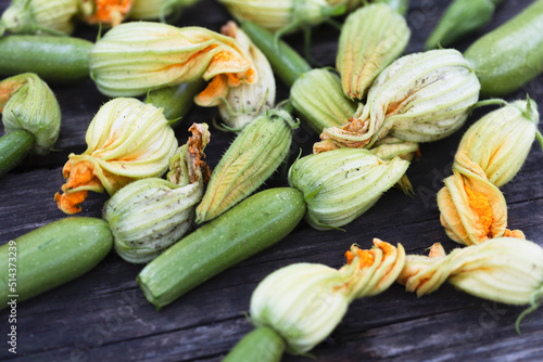 zucchini with flowers on a wooden background