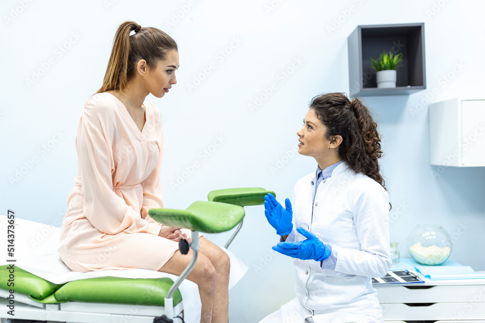Gynecologist talking with young female patient during medical consultation in modern clinic. Patient with a gynecologist during the consultation in the gynecological office Gynecologist talking with young female patient during medical consultation in modern clinic. Patient with a gynecologist during the consultation in the gynecological office