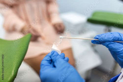 Vaginal Smear. Close-up of doctor hand holds gynecological examination instruments. Gynecologist working in the obstetrics and gynecology clinic. photo