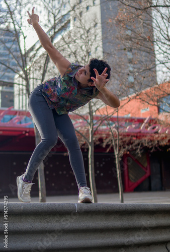 low angle shot of a female artist doing physical movements of butoh dance