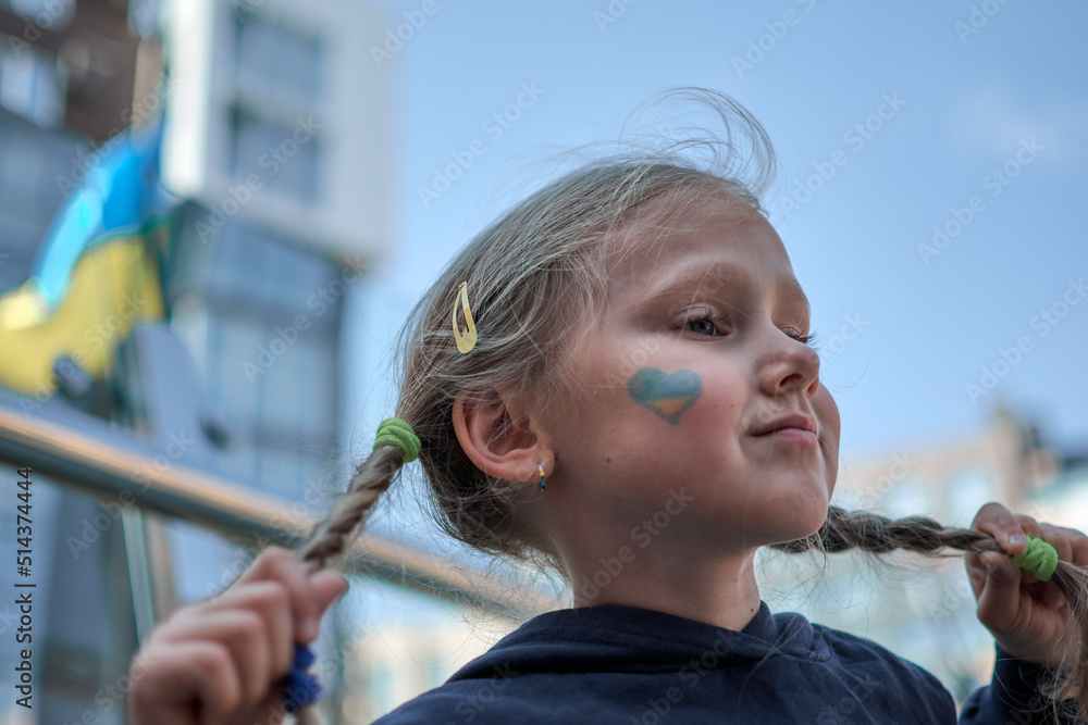 Girl with painted Ukraine flag yellow and blue. Stop the war and the power of Ukraine, patriotism Girl with painted Ukraine flag yellow and blue. Stop the war and the power of Ukraine, patriotism