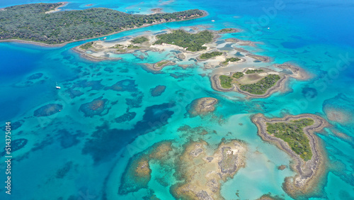 Fototapeta Naklejka Na Ścianę i Meble -  Aerial drone photo of paradise volcanic island complex resembling a blue lagoon archipelago in exotic destination bay with deep turquoise sea and crystal clear water beach