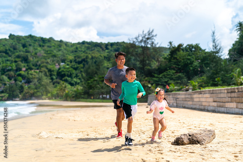 Happy Asian family grandfather jogging exercise with little grandchild boy and girl on tropical beach. Healthy senior man and children kid enjoy outdoor activity sport training on summer vacation © CandyRetriever 