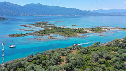 Aerial drone photo of tropical exotic volcanic island complex of Lihadonisia forming a blue lagoon and small islet of Monolia with turquoise clear organised beach, north Evia island, Greece