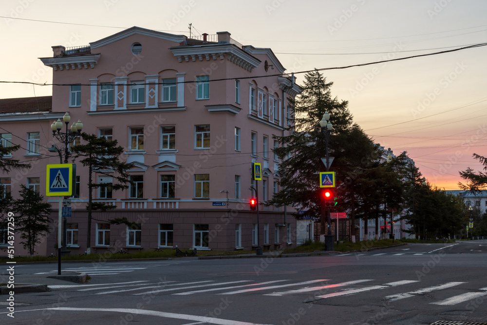 Fototapeta premium Morning cityscape. View of empty streets, crossroads, crosswalk and building. Red traffic light. City of Magadan, Magadan region, Far East of Russia.