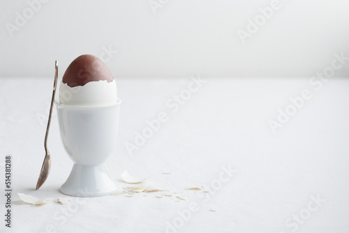 Chocolate egg on white eggstand holder photo