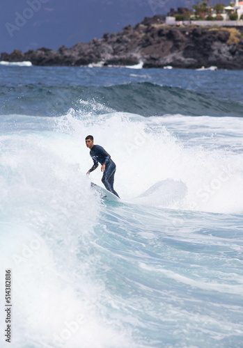 PUERTO DE SANTIAGO, TENERIFE - JUNE 2022: surfer riding the waves in Tenerife © Melinda Nagy