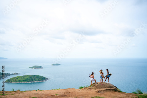 Group of Healthy Asian woman skater skating and hiking to mountain peak at tropical island on summer travel vacation. Female friends enjoy outdoor activity lifestyle adventure extreme sport together