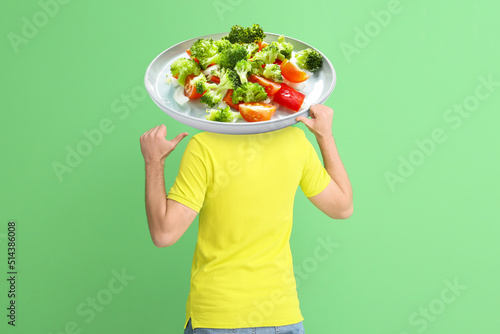 Young man with plate of tas...