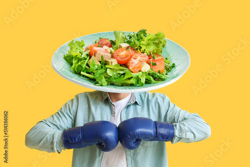 Young man in boxing gloves ...