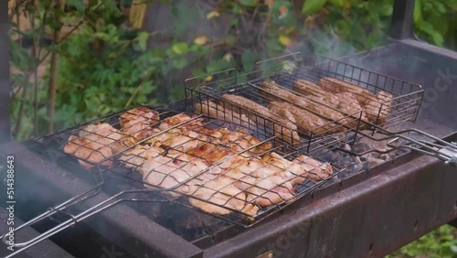 Meat is grilled on the grill in nature.