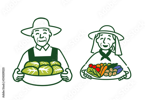 収穫した野菜を持つ夫婦