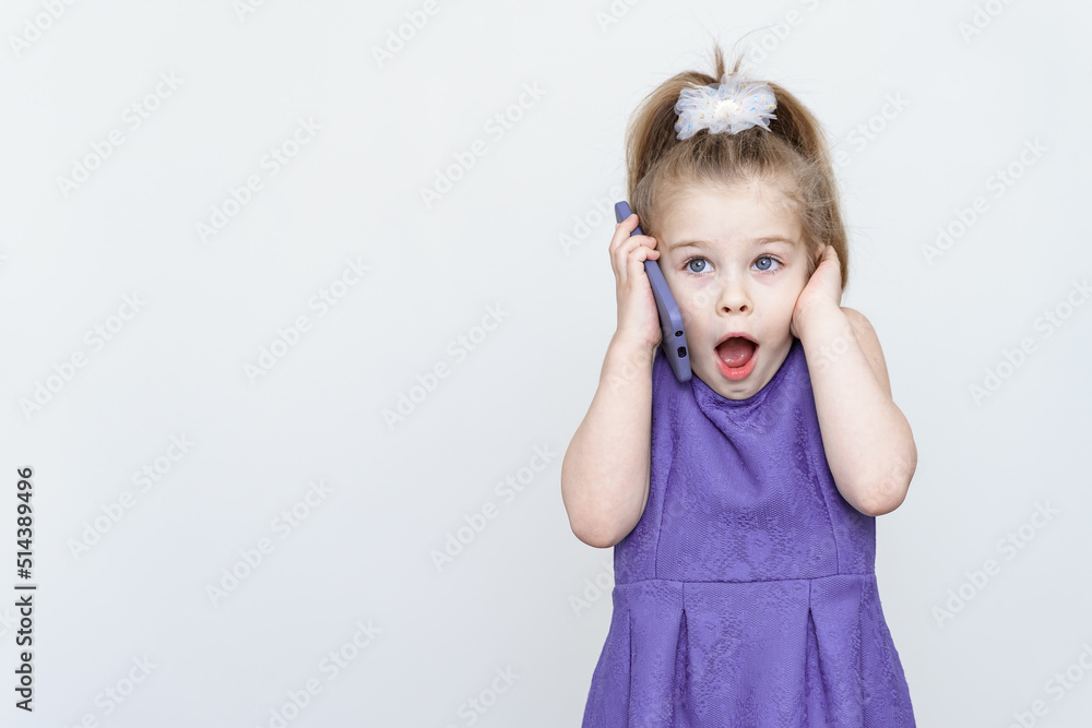surprised and shocked little girl talking on the phone. place for text, copy space surprised and shocked little girl talking on the phone. place for text, copy space