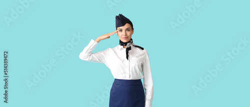 Beautiful stewardess on light blue background photo