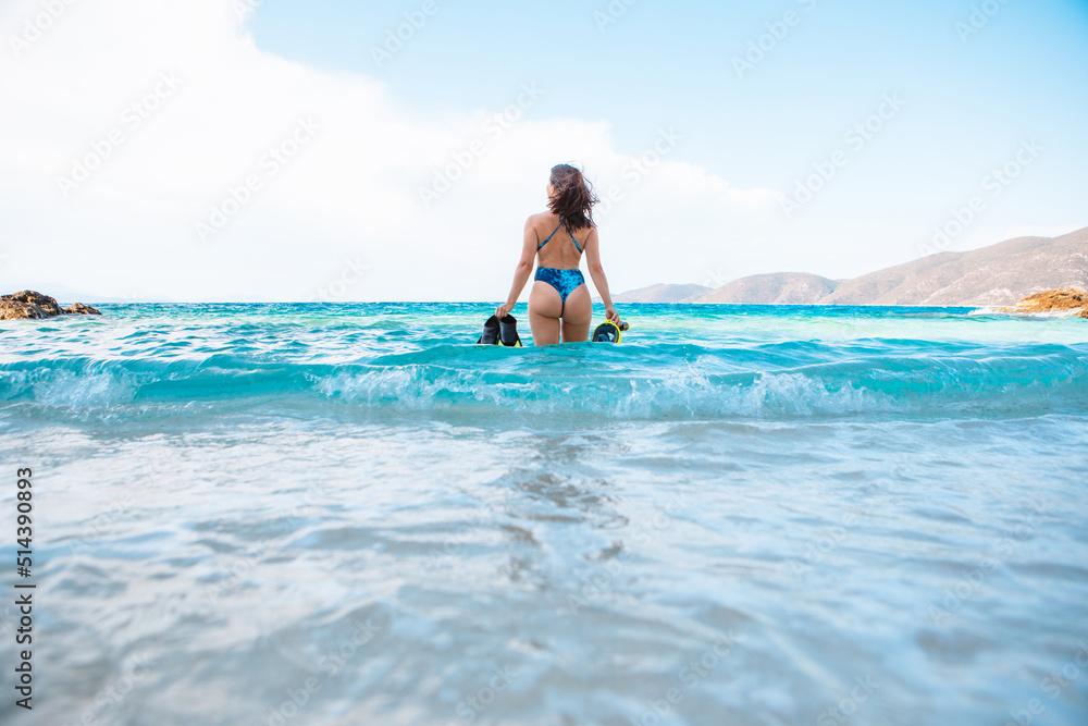 sexy woman in blue swimsuit going to the sea with with flippers and snorkeling mask sexy woman in blue swimsuit going to the sea with with flippers and snorkeling mask