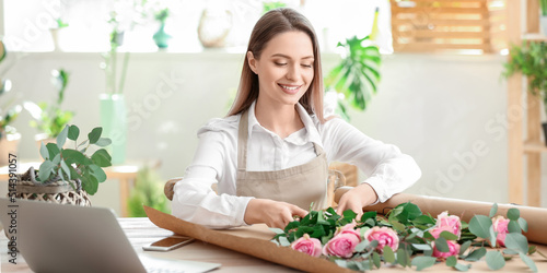 Young female florist workin...
