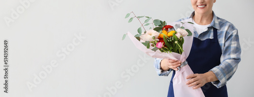 Mature female florist holdi...
