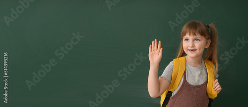 Cute little schoolgirl near...