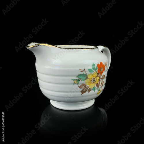 antique milk jug with floral pattern. retro vessel for milk. coffee service. vintage gravy boat