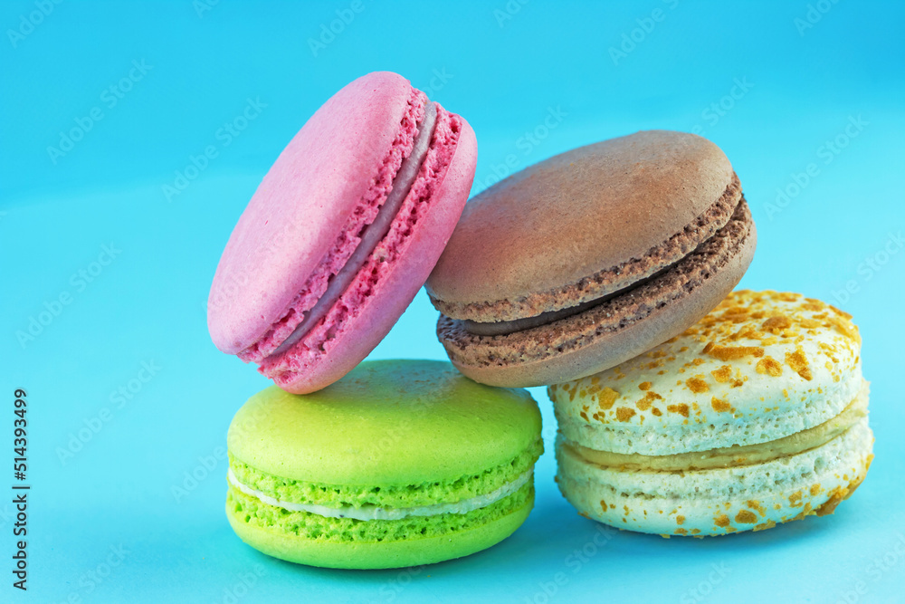 Colored delicious macaroons on a blue background. Colored delicious macaroons on a blue background.