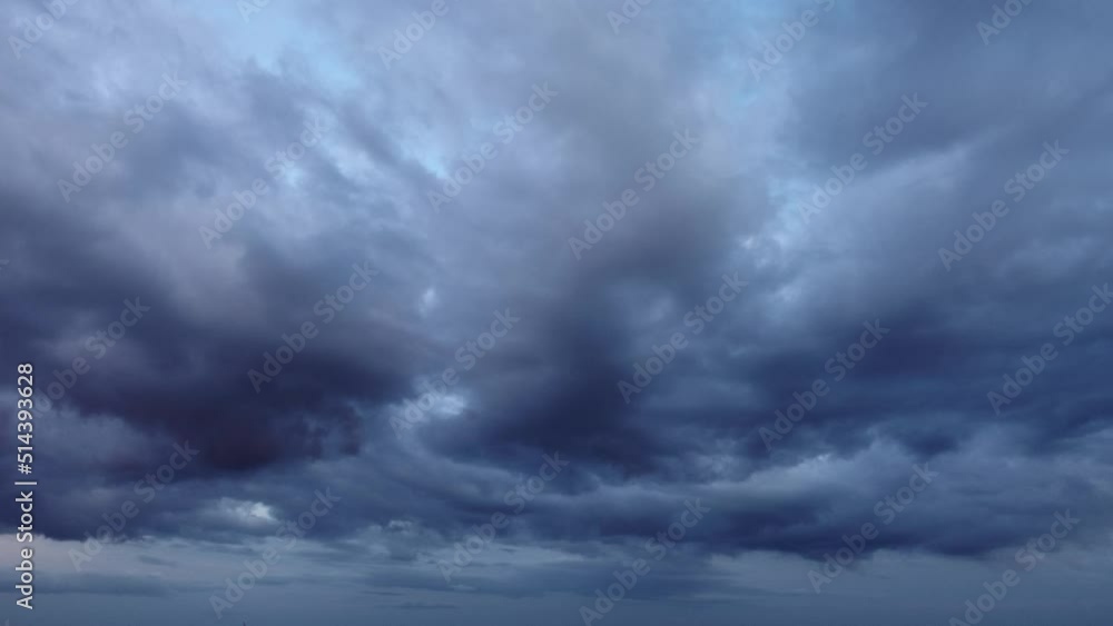 Dark grey stratocumulus storm clouds moving quickly in the sky Dark grey stratocumulus storm clouds moving quickly in the sky