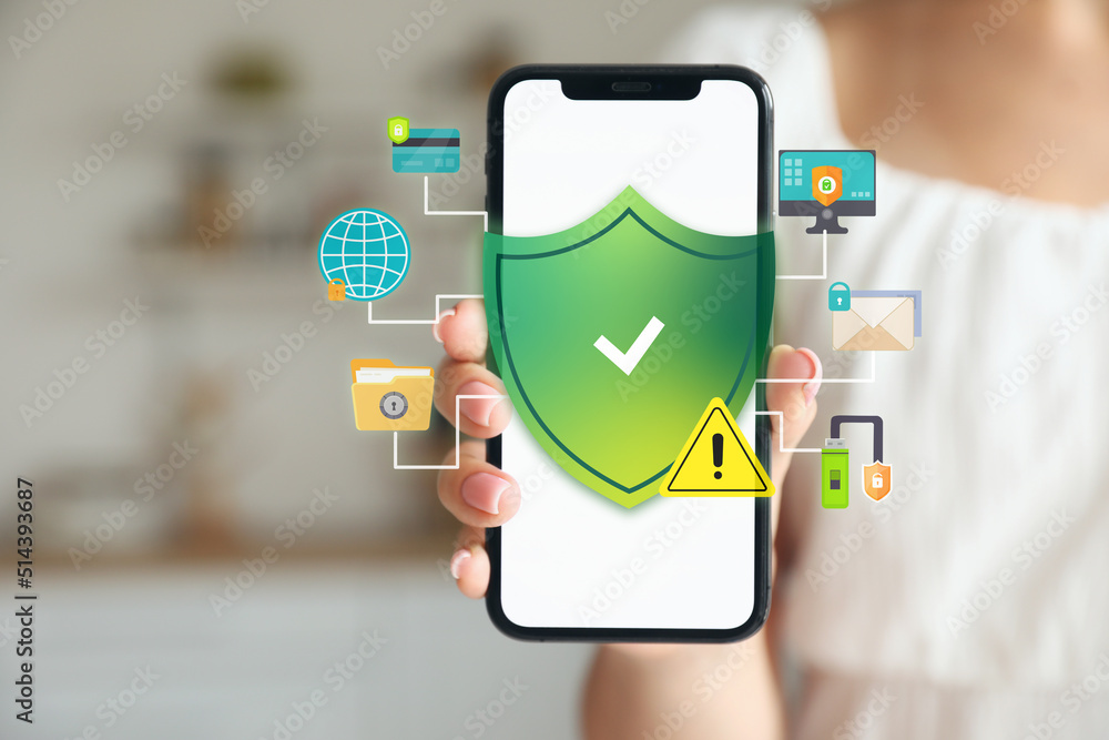 Young woman holding mobile phone, closeup. Antivirus concept Young woman holding mobile phone, closeup. Antivirus concept