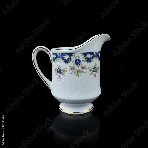 antique milk jug with floral pattern. retro vessel for milk. coffee service. vintage gravy boat